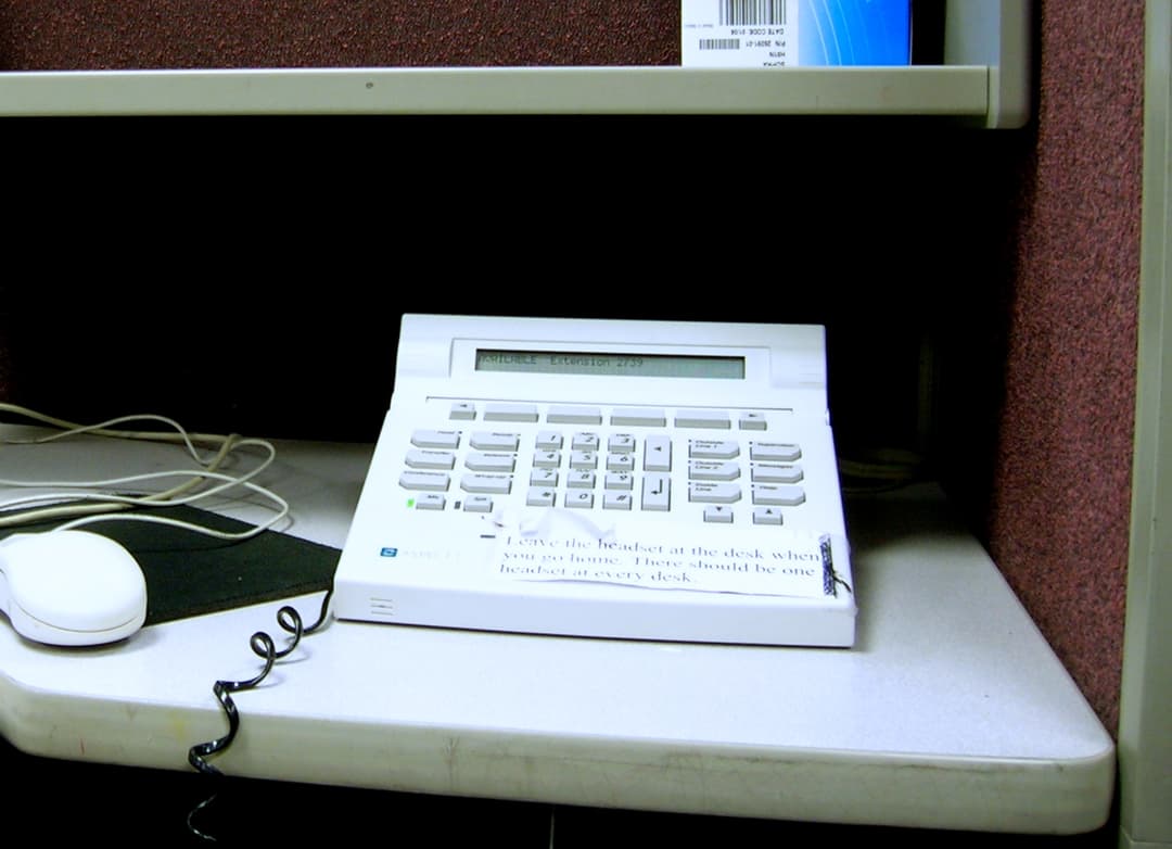 A customer support team reviewing call analytics on a CRM dashboard in a modern office